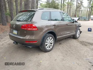 2014 Volkswagen Touareg Sport with VIN WVGEF9BP2ED007904, listed as a IAAI auction lot 41960811 with 126,230 mi miles and . Bid and sale history available at DreamBid. Image 4.