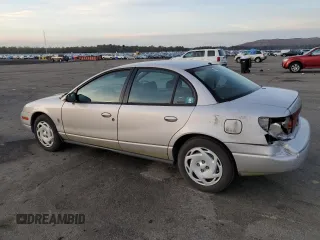 2001 Saturn SL z VIN 1G8ZK52761Z204012, wystawiony jako Copart lot #86618384 z przebiegiem 99 674 mil mil oraz Szkoda całkowita • Salvage title. Historia ofert i sprzedaży dostępna na DreamBid. Obrazek 2.