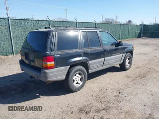1997 Jeep Grand Cherokee Laredo with VIN 1J4GZ58S4VC633205, listed as a IAAI auction lot 41727571 with 201,228 mi miles. Bid and sale history available at carsss.com. Image 4.