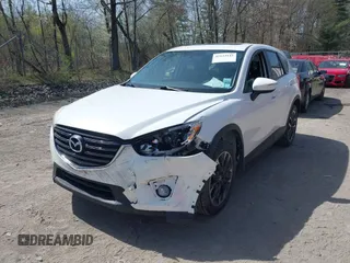 2016 Mazda CX-5 Grand Touring with VIN JM3KE4DY0G0632693, listed as a IAAI auction lot 42123142 with 106,592 mi miles. Bid and sale history available at carsss.com. Image 6.