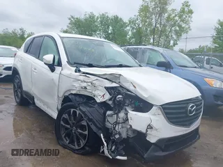 2016 Mazda CX-5 Grand Touring z VIN JM3KE4DY5G0896685, wystawiony jako IAAI lot #42203346 z przebiegiem 80 045 mil mil oraz . Historia ofert i sprzedaży dostępna na DreamBid. Obrazek 1.