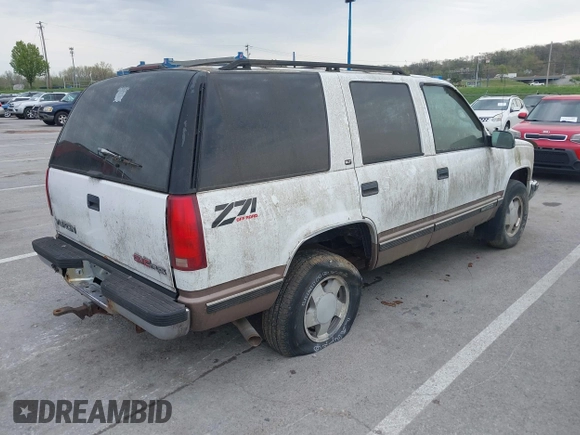 1997 GMC Yukon with VIN 1GKEK13R2VJ739795, listed as a IAAI auction lot 42011678 with 185,306 mi miles. Bid and sale history available at carsss.com. Image 4.