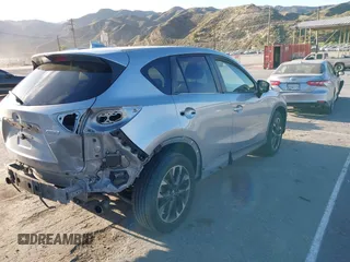 2016 Mazda CX-5 Grand Touring z VIN JM3KE2DY8G0709573, wystawiony jako IAAI lot #42021005 z przebiegiem 113 941 mil mil oraz . Historia ofert i sprzedaży dostępna na DreamBid. Obrazek 4.