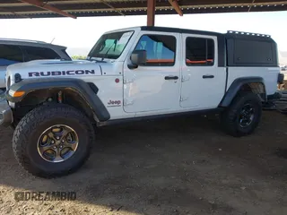 2022 Jeep Gladiator Rubicon with VIN 1C6JJTBM6NL145009, listed as a IAAI auction lot 42134143 with 59,438 mi miles and . Bid and sale history available at DreamBid. Image 2.