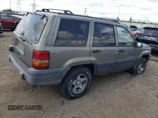 1997 Jeep Grand Cherokee Laredo z VIN 1J4GZ58S4VC502596, wystawiony jako Copart lot #88255865 z przebiegiem Nie podano mil oraz Nie do naprawy • Non repairable. Historia ofert i sprzedaży dostępna na DreamBid. Obrazek 3.