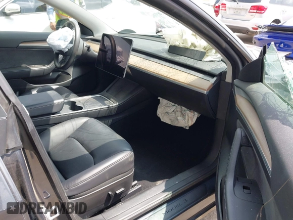 2023 Tesla Model 3 with VIN 5YJ3E1EA0PF518904, listed as a IAAI auction lot 42058540 with 20,945 mi miles and . Bid and sale history available at DreamBid. Image 5.