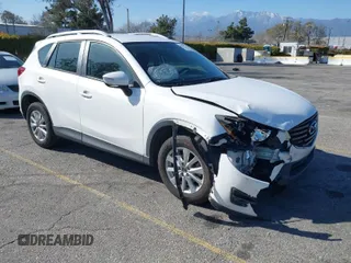 2016 Mazda CX-5 Sport with VIN JM3KE2BY9G0879654, listed as a IAAI auction lot 41819154 with 65,586 mi miles. Bid and sale history available at carsss.com. Image 1.