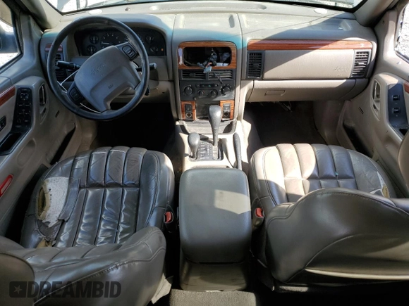 1999 Jeep Grand Cherokee Limited with VIN 1J4GW68S2XC677334, listed as a Copart auction lot 74152054 with 242,220 mi miles and Salvage Title. Bid and sale history available at carsss.com. Image 8.