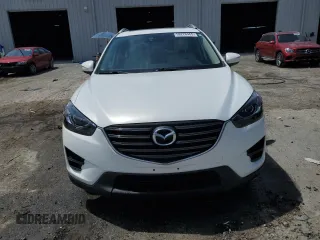 2016 Mazda CX-5 Grand Touring z VIN JM3KE2DYXG0731462, wystawiony jako Copart lot #58220465 z przebiegiem 130 033 mil mil oraz Szkoda całkowita • Salvage title. Historia ofert i sprzedaży dostępna na DreamBid. Obrazek 5.