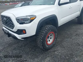 2023 Toyota Tacoma SR with VIN 3TMCZ5AN2PM641846, listed as a IAAI auction lot 41948660 with 21,969 mi miles and . Bid and sale history available at DreamBid. Image 6.
