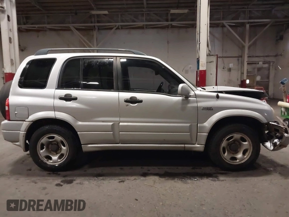 2002 Suzuki Grand Vitara JLX z VIN JS3TD62V324161291, wystawiony jako IAAI lot #41577344 z przebiegiem 164 658 mil mil oraz . Historia ofert i sprzedaży dostępna na DreamBid. Obrazek 13.