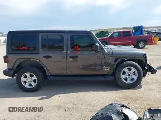 2019 Jeep Wrangler Unlimited Sport S with VIN 1C4HJXDG0KW541940, listed as a IAAI auction lot 42100255 with 68,309 mi miles and . Bid and sale history available at DreamBid. Image 14.