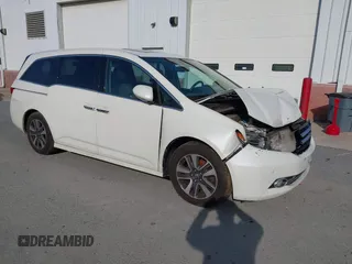 2014 Honda Odyssey Touring with VIN 5FNRL5H94EB001479, listed as a IAAI auction lot 41123678 with 147,269 mi miles and . Bid and sale history available at carsss.com. Image 1.