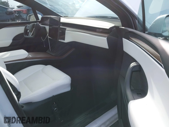2023 Tesla Model X with VIN 7SAXCBE54PF384403, listed as a IAAI auction lot 40947187 with 16,881 mi miles and . Bid and sale history available at DreamBid. Image 5.