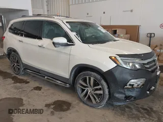 2017 Honda Pilot Touring with VIN 5FNYF6H92HB032873, listed as a IAAI auction lot 41608870 with 123,888 mi miles. Bid and sale history available at carsss.com. Image 1.