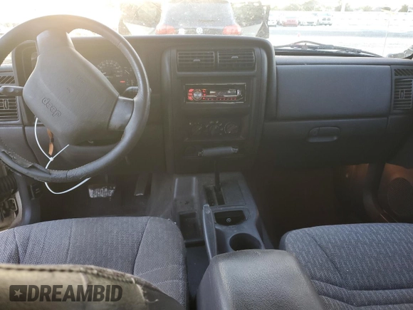 1999 Jeep Cherokee Sport with VIN 1J4FT68S6XL578679, listed as a Copart auction lot 76697394 with 196,110 mi miles and Salvage title. Bid and sale history available at DreamBid. Image 8.