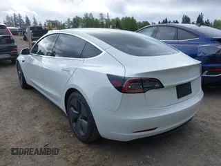 2020 Tesla Model 3 Standard Range Plus with VIN 5YJ3E1EA5LF613002, listed as a IAAI auction lot 42129085 with 55,672 mi miles. Bid and sale history available at carsss.com. Image 3.