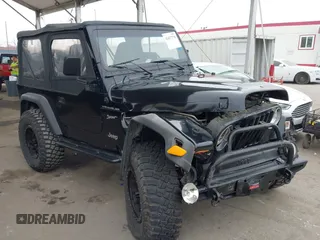 2002 Jeep Wrangler Sport z VIN 1J4FA49S02P705470, wystawiony jako IAAI lot #42477770 z przebiegiem 59 395 mil mil oraz . Historia ofert i sprzedaży dostępna na DreamBid. Obrazek 1.