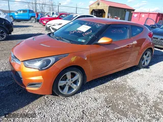 2015 Hyundai Veloster with VIN KMHTC6AD2FU225073, listed as a IAAI auction lot 41571336 with 128,819 mi miles. Bid and sale history available at carsss.com. Image 2.