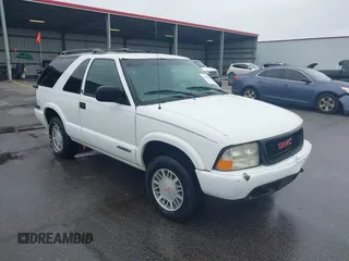 2001 GMC Jimmy SLS Comfort/Convenience z VIN 1GKCT18W41K258776, wystawiony jako IAAI lot #42328899 z przebiegiem 194 088 mil mil oraz . Historia ofert i sprzedaży dostępna na DreamBid. Obrazek 1.