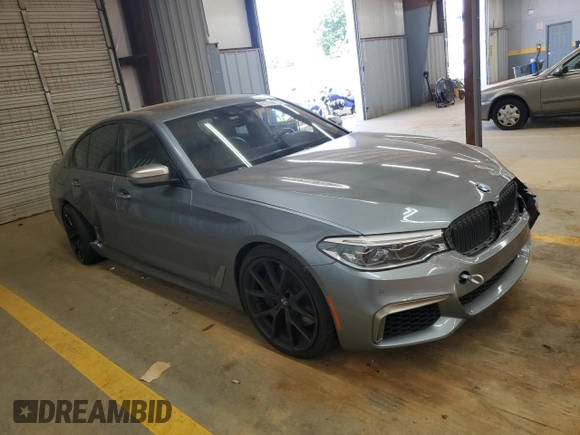 2018 BMW 5 Series M550i xDrive with VIN WBAJB9C55JB050213, listed as a Copart auction lot 61714255 with 34,700 mi miles and Salvage title. Bid and sale history available at DreamBid. Image 4.