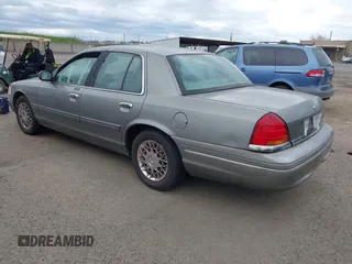 1999 Ford Crown Victoria LX z VIN 2FAFP74W4XX192490, wystawiony jako IAAI lot #41791909 z przebiegiem 115 469 mil mil oraz . Historia ofert i sprzedaży dostępna na DreamBid. Obrazek 3.