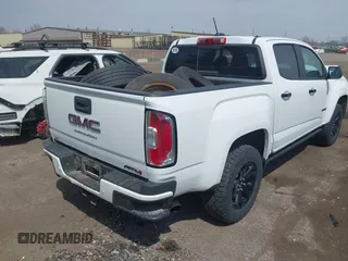 2021 GMC Canyon 4WD AT4 z VIN 1GTG6FENXM1291689, wystawiony jako IAAI lot #42038884 z przebiegiem 54 884 mil mil oraz . Historia ofert i sprzedaży dostępna na DreamBid. Obrazek 4.