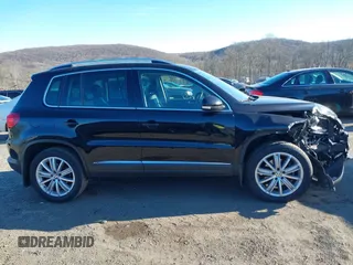 2014 Volkswagen Tiguan S z VIN WVGBV3AX4EW581302, wystawiony jako IAAI lot #41033175 z przebiegiem 69 791 mil mil oraz . Historia ofert i sprzedaży dostępna na DreamBid. Obrazek 13.