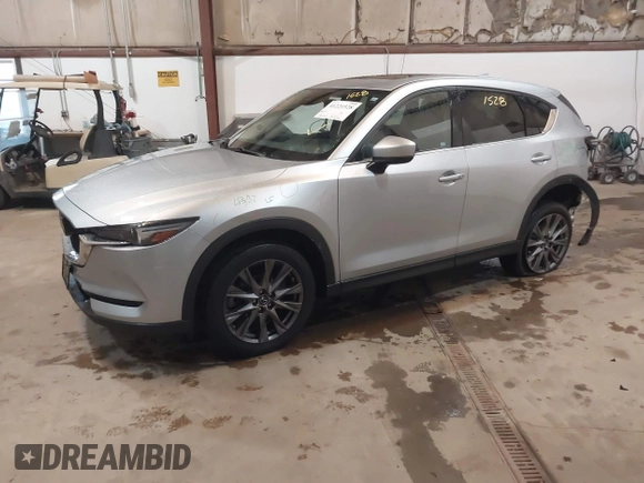 2021 Mazda CX-5 Grand Touring with VIN JM3KFADMXM1318015, listed as a IAAI auction lot 41221528 with 79,473 mi miles. Bid and sale history available at carsss.com. Image 2.