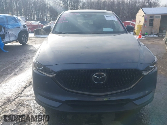 2021 Mazda CX-5 Touring z VIN JM3KFBCMXM0463469, wystawiony jako IAAI lot #41488993 z przebiegiem 28 582 mil mil oraz . Historia ofert i sprzedaży dostępna na DreamBid. Obrazek 12.