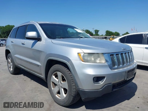 2012 Jeep Grand Cherokee Laredo with VIN 1C4RJEAG5CC112230, listed as a IAAI auction lot 41997483 with 302,923 mi miles. Bid and sale history available at carsss.com. Image 1.