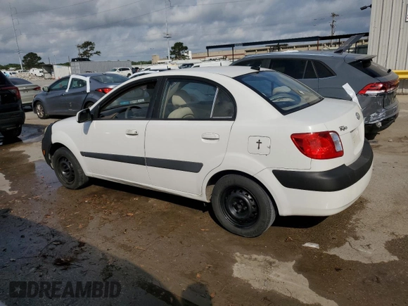 2009 Kia Rio LX with VIN KNADE223X96439445, listed as a Copart auction lot 54619335 with 102,120 mi miles and Salvage Title. Bid and sale history available at DreamBid. Image 2.