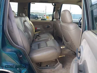 1999 GMC Yukon with VIN 1GKEK13R3XJ717999, listed as a IAAI auction lot 41870187 with 179,855 mi miles. Bid and sale history available at carsss.com. Image 8.