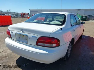 1998 Mazda 626 DX with VIN 1YVGF22CXW5702980, listed as a IAAI auction lot 41778063 with 104,672 mi miles. Bid and sale history available at carsss.com. Image 4.