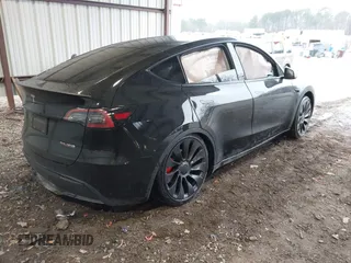 2023 Tesla Model Y Performance with VIN 7SAYGDEF2PF800641, listed as a IAAI auction lot 41612596 with 60,984 mi miles and . Bid and sale history available at DreamBid. Image 4.