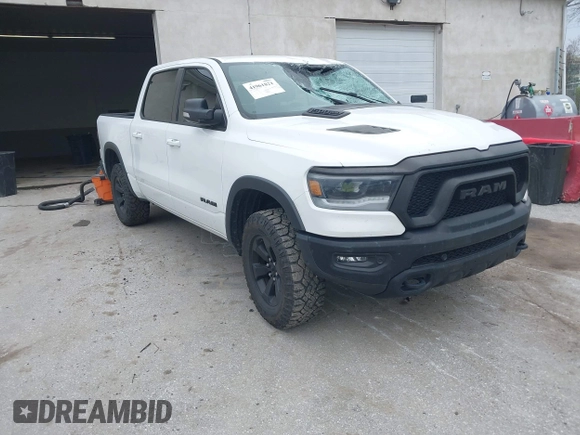 2022 Ram 1500 Rebel z VIN 1C6SRFLT1NN267513, wystawiony jako IAAI lot #41961821 z przebiegiem 140 488 mil mil oraz . Historia ofert i sprzedaży dostępna na DreamBid. Obrazek 1.