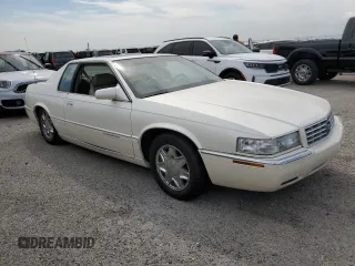 1999 Cadillac Eldorado z VIN 1G6EL12Y7XU615169, wystawiony jako Copart lot #76459744 z przebiegiem Nie podano mil oraz Szkoda całkowita • Salvage title. Historia ofert i sprzedaży dostępna na DreamBid. Obrazek 4.
