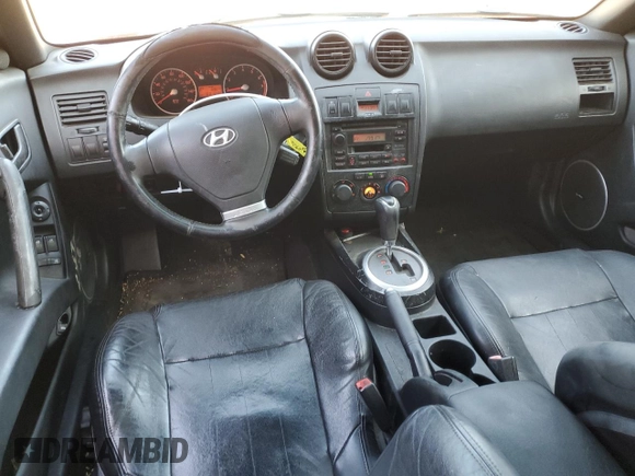 2003 Hyundai Tiburon GT z VIN KMHHN65F63U060104, wystawiony jako Copart lot #84560184 z przebiegiem 160 120 mil mil oraz Czysty tytuł • Clean title. Historia ofert i sprzedaży dostępna na DreamBid. Obrazek 8.