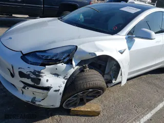 2020 Tesla Model 3 Standard Range Plus with VIN 5YJ3E1EA1LF615250, listed as a IAAI auction lot 41444030 with 76,810 mi miles. Bid and sale history available at carsss.com. Image 6.