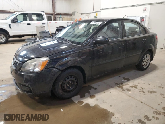 2010 Kia Rio with VIN KNADH4B37A6641845, listed as a Copart auction lot 51861215 with 163,894 mi miles and Salvage Title. Bid and sale history available at DreamBid. Image 1.