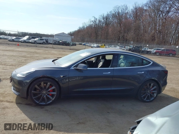 2018 Tesla Model 3 Long Range Battery with VIN 5YJ3E1EB5JF063077, listed as a IAAI auction lot 41773551 with 99,477 mi miles and . Bid and sale history available at DreamBid. Image 14.