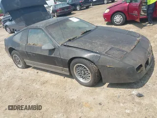 1987 Pontiac Fiero GT z VIN 1G2PG1198HP209135, wystawiony jako IAAI lot #42404122 z przebiegiem 99 897 mil mil oraz . Historia ofert i sprzedaży dostępna na DreamBid. Obrazek 1.