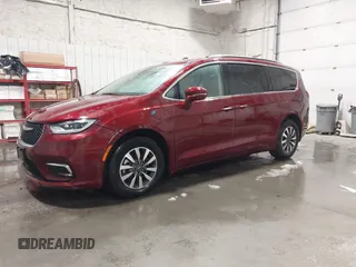 2021 Chrysler Pacifica Hybrid Touring L with VIN 2C4RC1L71MR581260, listed as a IAAI auction lot 42014401 with 68,719 mi miles and . Bid and sale history available at DreamBid. Image 2.