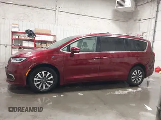 2021 Chrysler Pacifica Hybrid Touring L with VIN 2C4RC1L71MR581260, listed as a IAAI auction lot 42014401 with 68,719 mi miles and . Bid and sale history available at DreamBid. Image 14.