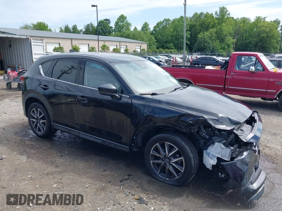 2018 Mazda CX-5 Grand Touring z VIN JM3KFBDM5J0307785, wystawiony jako IAAI lot #42302609 z przebiegiem 81 974 mil mil oraz . Historia ofert i sprzedaży dostępna na DreamBid. Obrazek 1.