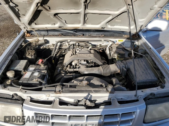 1999 Isuzu Rodeo S z VIN 4S2CM58W8X4339006, wystawiony jako Copart lot #84285294 z przebiegiem 129 191 mil mil oraz Czysty tytuł • Clean title. Historia ofert i sprzedaży dostępna na DreamBid. Obrazek 12.