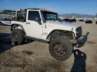 2010 Jeep Wrangler Sport with VIN 1J4AA2D16AL144842, listed as a Copart auction lot 50173535 with 106,000 mi miles and Salvage Title. Bid and sale history available at carsss.com. Image 4.