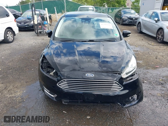 2016 Ford Focus Titanium z VIN 1FADP3J27GL215436, wystawiony jako IAAI lot #42709166 z przebiegiem 75 956 mil mil oraz . Historia ofert i sprzedaży dostępna na DreamBid. Obrazek 13.