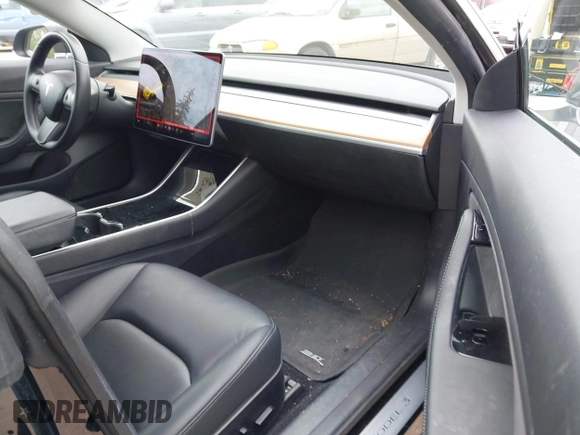 2019 Tesla Model 3 Mid Range with VIN 5YJ3E1EA6KF415656, listed as a IAAI auction lot 42140763 with 71,408 mi miles and . Bid and sale history available at carsss.com. Image 5.
