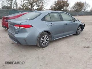 2021 Toyota Corolla Hybrid LE with VIN JTDEAMDE8MJ002711, listed as a IAAI auction lot 41498716 with 98,559 mi miles. Bid and sale history available at carsss.com. Image 4.